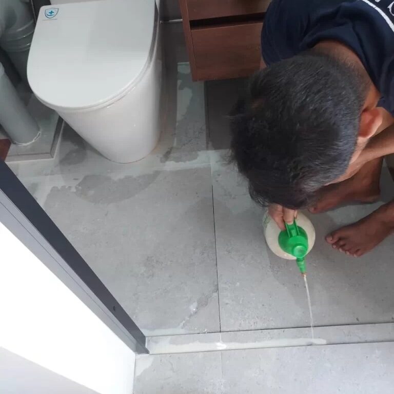 Waterproofing treatment being applied in the toilet room