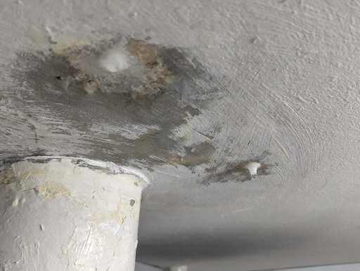 white ceiling with a leak stain